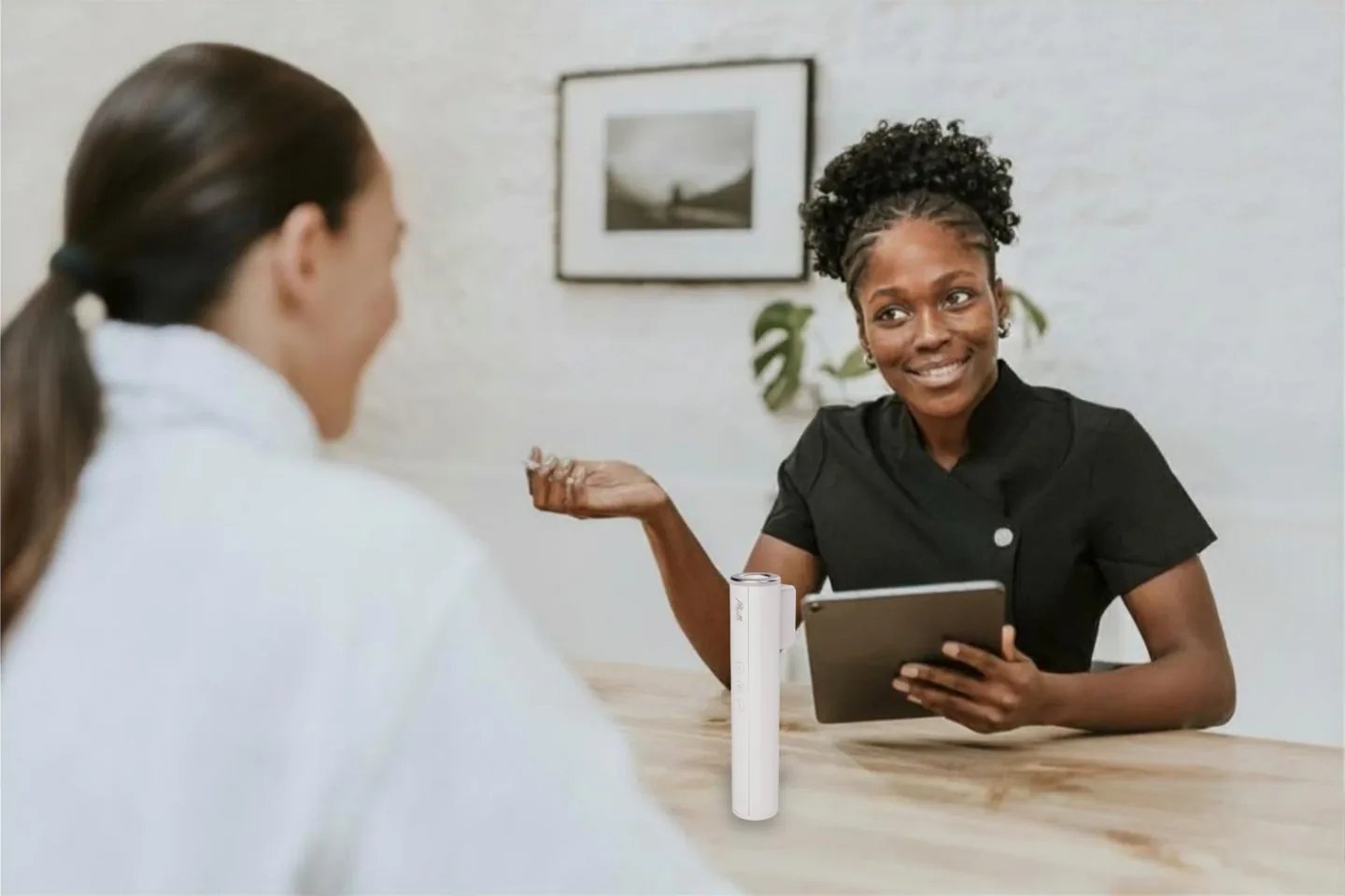 A skincare professional reviewing Muilli scan results on a tablet with a client during a consultation